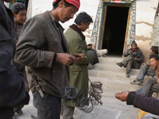 In Jiangpo Village in Deqin County of Yunnan Province in China, PCD supports the protection of wildlife. Activities include patrolling the mountains, and after the patrolling the villagers remove animal traps such as the wire snare in the hands of the man on the left.